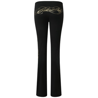 Black flared pants with a gold cursive script logo printed across the upper back, shown against a plain white background.